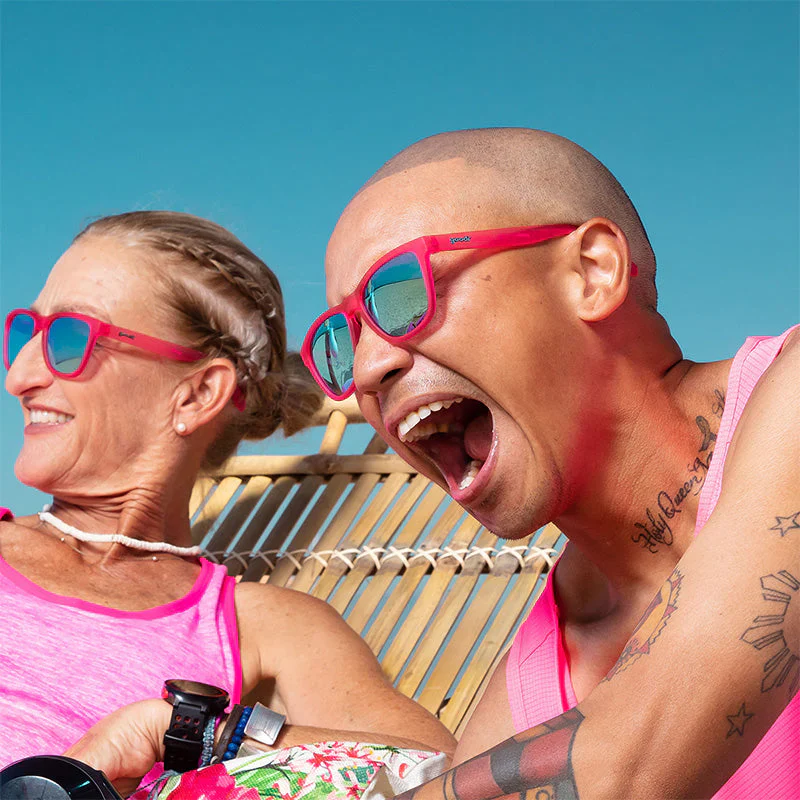 goodr OG Flamingos On A Booze Cruise sunglasses, hot pink frame with mirrored sky blue lenses — styled product view
