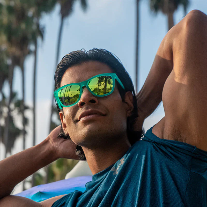 goodr OG Nessy's Midnight Orgy sunglasses, aqua frame with champagne lenses — styled product view