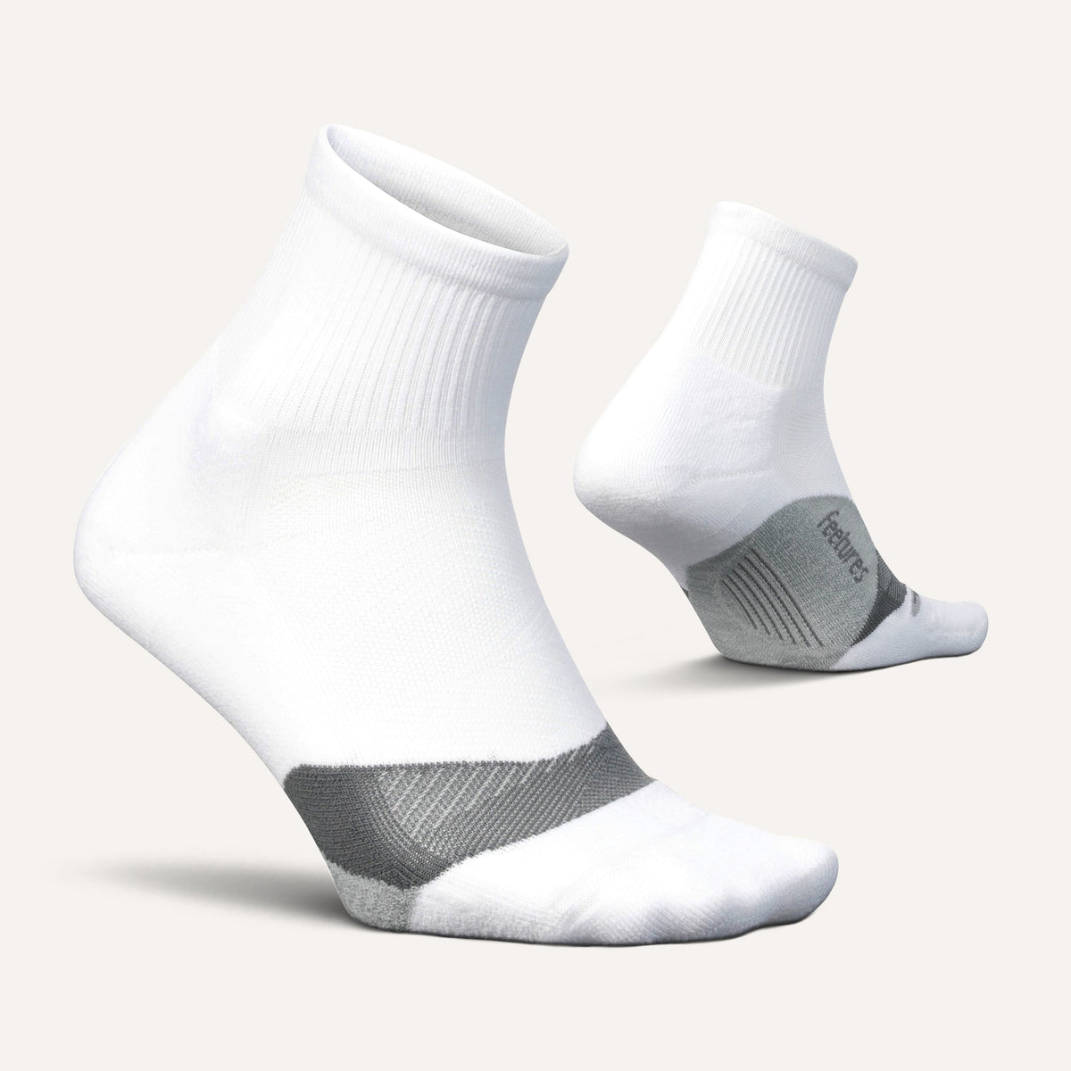 Feetures Elite Light Cushion Quarter sock in White — pair view #Colour_White