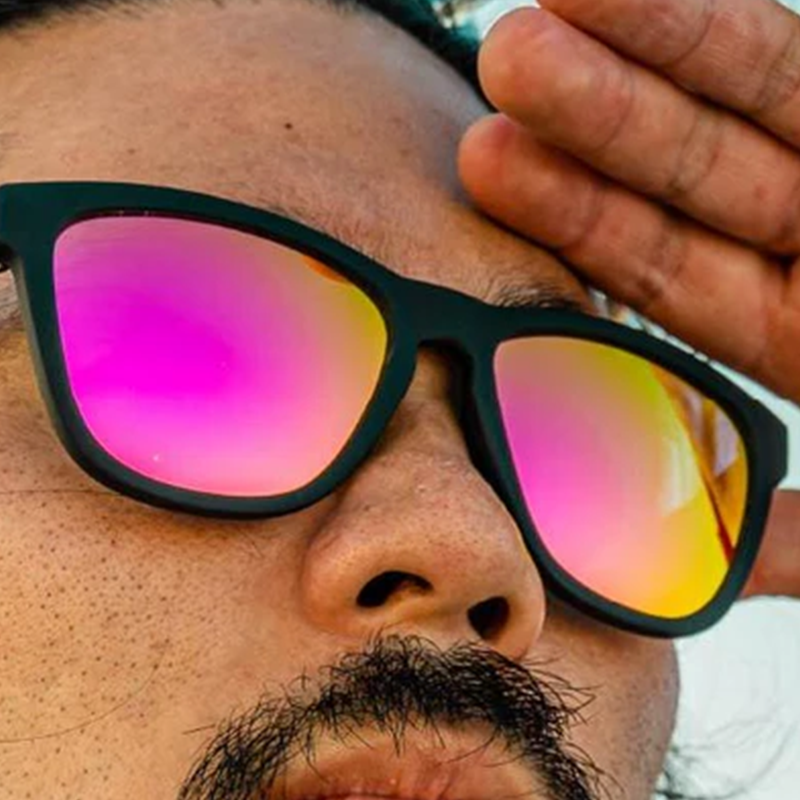 goodr OG Professional Respawner sunglasses, charcoal frame with hot pink lenses — styled product view