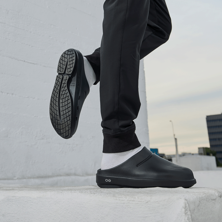 OOFOS OOcloog Clog — Black, worn balancing outside