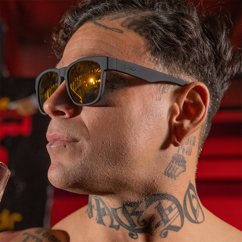 goodr BFG Beelzebub's Bourbon Burpees sunglasses, smoke frame with mirrored amber lenses — styled product view