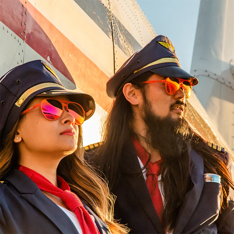 goodr Mach G Captain Blunt's Red Eye sunglasses, coral frame with crimson mirrored lenses — styled product view