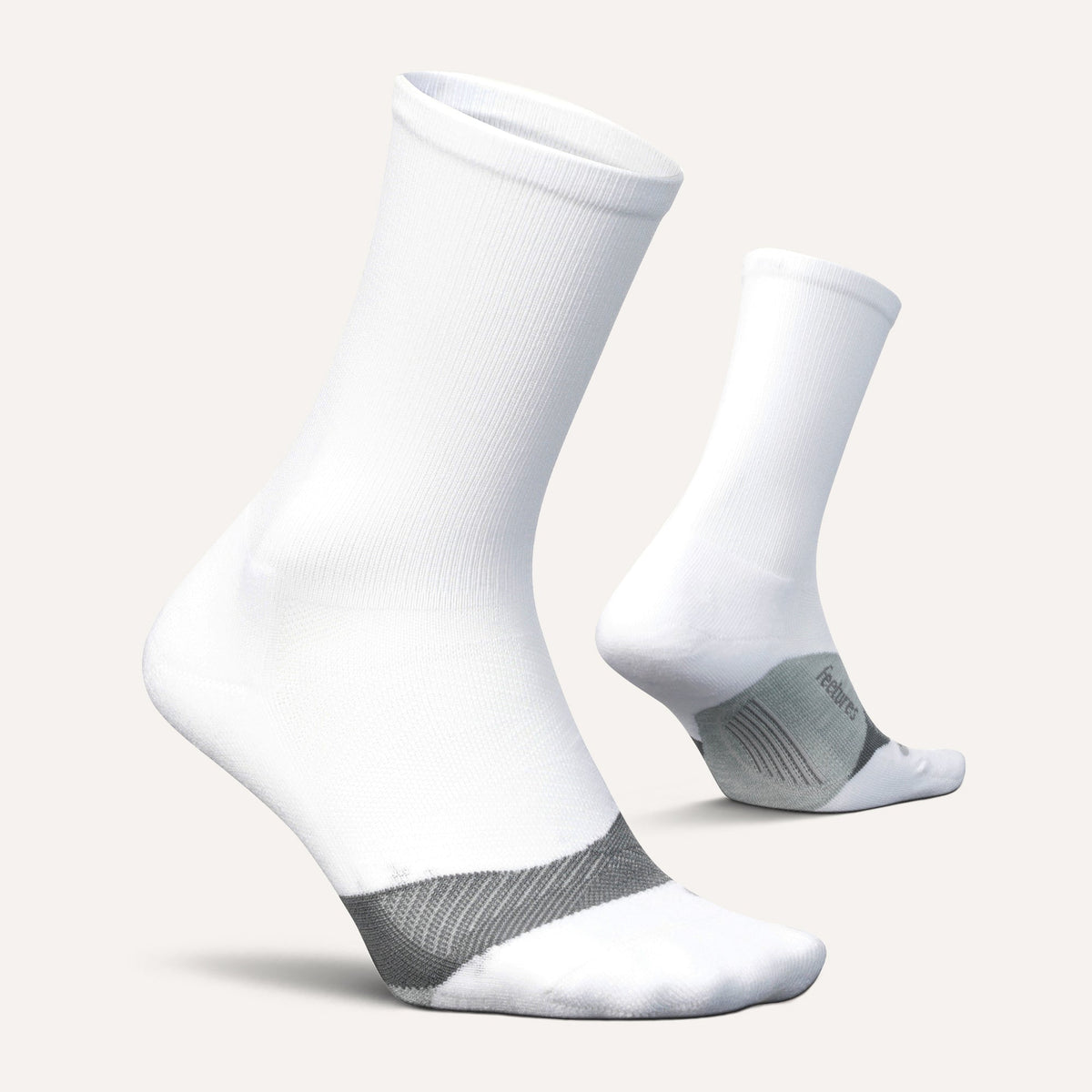 Feetures Elite Light Cushion Mini Crew sock in White — pair view #Color_White